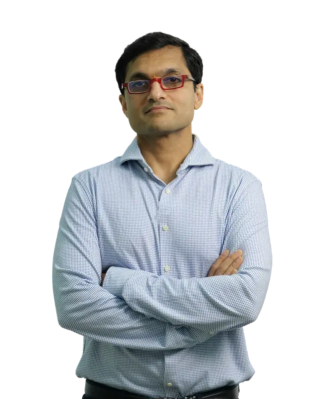 Dr. Sanket Mehta in a light-blue shirt, arms crossed.