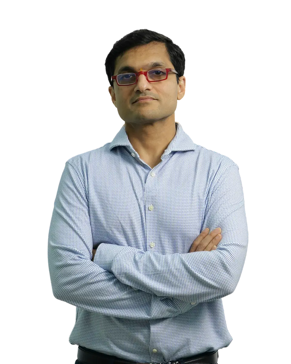 Dr. Sanket Mehta in a light-blue shirt, arms crossed.