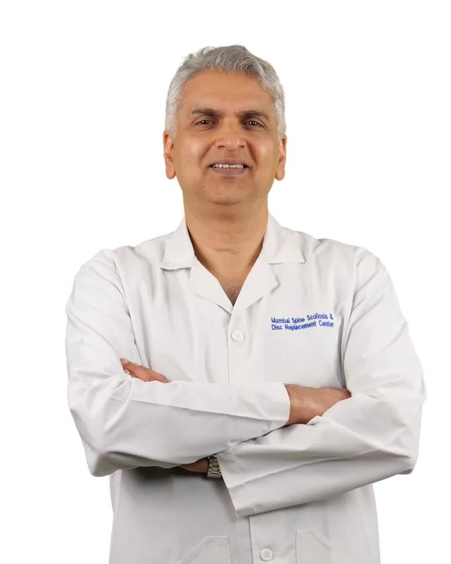 Dr. Arvind Kulkarni in a white coat, arms crossed, smiling.
